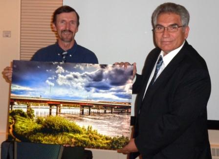  College of Engineering Dean Georges Kipouros receives a print of the South Circle Bridge as recognition of the College's Centennial
